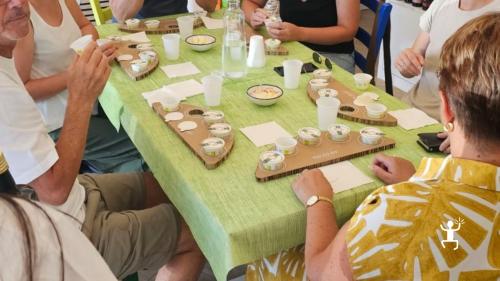 Eine Gruppe sitzt im Verkostungsraum in Salerno, mit kleinen Olivenölbehältern auf individuellen Verkostungstabletts