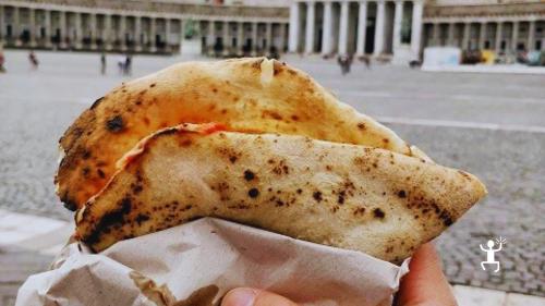 Esperienza street food a Napoli con degustazione di pizza a portafoglio durante un tour gastronomico perfetta per famiglie